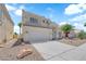 The bright two-story home is complemented by desert landscaping, a two-car garage and mature palm trees at 4604 Barnes Ct, Las Vegas, NV 89147