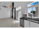 Bright kitchen featuring stainless steel appliances and a view of the living room fireplace at 4604 Barnes Ct, Las Vegas, NV 89147