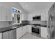 Bright kitchen featuring stainless steel appliances and granite countertops at 4604 Barnes Ct, Las Vegas, NV 89147