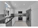 Modern kitchen featuring stainless steel appliances and granite countertops at 4604 Barnes Ct, Las Vegas, NV 89147