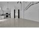 Spacious living room featuring an open floor plan and staircase to the upper level at 4604 Barnes Ct, Las Vegas, NV 89147