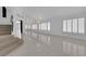 Bright living room with white tile floor, shutters, and stairs at 4604 Barnes Ct, Las Vegas, NV 89147