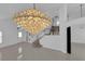 Bright living room with tile floor, stairs, and modern chandelier at 4604 Barnes Ct, Las Vegas, NV 89147
