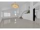 Bright living room with tile floor, stairs, and modern chandelier at 4604 Barnes Ct, Las Vegas, NV 89147