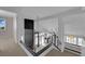 Open loft area showcases a black fireplace accent wall and stylish glass railings at 4604 Barnes Ct, Las Vegas, NV 89147