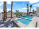 A refreshing pool and spa are surrounded by desert landscaping and palm trees in a private backyard at 4604 Barnes Ct, Las Vegas, NV 89147