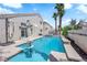 Backyard pool with blue water and palm trees on a sunny day at 4604 Barnes Ct, Las Vegas, NV 89147