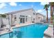 Exterior view of the sparkling pool, spa and backyard landscaping with access to home through sliding glass doors at 4604 Barnes Ct, Las Vegas, NV 89147