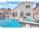 The backyard has a sparkling pool and integrated spa with access to the house through sliding glass doors at 4604 Barnes Ct, Las Vegas, NV 89147