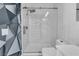 Shower features glass door, marble tile surround and rainfall shower head at 4604 Barnes Ct, Las Vegas, NV 89147