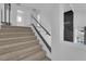 Carpeted staircase features a glass railing, providing an open and modern feel at 4604 Barnes Ct, Las Vegas, NV 89147