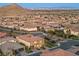 Elevated view of a desert community showcasing houses, landscaping, and mountain backdrop at 4702 Amazing View St, Las Vegas, NV 89129