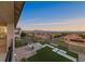 Backyard view featuring a manicured lawn, patio area, lush landscaping, and stunning mountain views at 4702 Amazing View St, Las Vegas, NV 89129