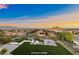 Stunning backyard featuring a green lawn, modern patio furniture, and views of the city at 4702 Amazing View St, Las Vegas, NV 89129