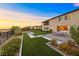 A serene backyard with pavers, lush greenery, and a tranquil outdoor dining spot at 4702 Amazing View St, Las Vegas, NV 89129