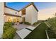 Beautiful backyard with a patio, seating area, green grass, and manicured landscaping at 4702 Amazing View St, Las Vegas, NV 89129