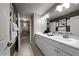 Elegant bathroom with dual sinks, white cabinetry, and a separate shower area at 4702 Amazing View St, Las Vegas, NV 89129