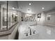 Luxurious bathroom featuring white cabinets, a soaking tub, a glass-enclosed shower and white tile flooring at 4702 Amazing View St, Las Vegas, NV 89129