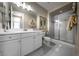Bathroom featuring double vanity, glass enclosed shower, and decorative lighting at 4702 Amazing View St, Las Vegas, NV 89129