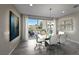 Modern dining room with glass table, seating for six, and patio access at 4702 Amazing View St, Las Vegas, NV 89129