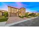 Charming two-story home with a three-car garage, paver driveway, and manicured lawn at 4702 Amazing View St, Las Vegas, NV 89129