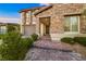 Detailed view of a house with stone facade, three-car garage, and manicured landscaping at 4702 Amazing View St, Las Vegas, NV 89129
