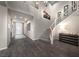 Spacious entryway with dark wood floors, staircase, and ample natural light at 4702 Amazing View St, Las Vegas, NV 89129