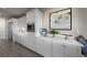 Bright kitchen with white cabinets, stainless steel appliances, and breakfast bar at 4702 Amazing View St, Las Vegas, NV 89129