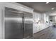 Modern kitchen with stainless steel refrigerator, custom cabinets, and view of the dining area at 4702 Amazing View St, Las Vegas, NV 89129
