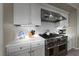 Close up of kitchen with stainless steel appliances, white cabinets, and tile backsplash at 4702 Amazing View St, Las Vegas, NV 89129