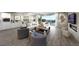 Open-concept living room with modern furnishings, fireplace, and sliding glass doors to the patio at 4702 Amazing View St, Las Vegas, NV 89129