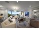 Open living room with modern fireplace, tile accent wall, and sliding doors to outdoor area at 4702 Amazing View St, Las Vegas, NV 89129