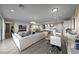 Open floor plan showcasing the living room, dining area, and kitchen with light hardwood floors at 4702 Amazing View St, Las Vegas, NV 89129