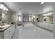 Bright and airy main bathroom with a soaking tub, dual vanities, and a glass-enclosed shower offers a spa-like experience at 4702 Amazing View St, Las Vegas, NV 89129