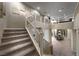 Bright and airy staircase leads to an open second-floor landing with views of the dining area at 4702 Amazing View St, Las Vegas, NV 89129
