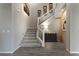 Elegant staircase with gray carpet runners, white railing, and stylish decor creates a warm and inviting entryway at 4702 Amazing View St, Las Vegas, NV 89129