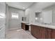 Bright bathroom featuring dual sinks, modern vanities, granite countertops, and tile flooring at 4829 E Beacon Ridge Dr, Pahrump, NV 89061