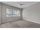 An empty bedroom with three bright windows and a ceiling fan at 4829 E Beacon Ridge Dr, Pahrump, NV 89061