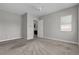 An empty bedroom with bright windows, neutral walls, plush carpet, and a walk-in closet at 4829 E Beacon Ridge Dr, Pahrump, NV 89061