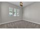 Bright bedroom with plush carpeting and a modern ceiling light at 4829 E Beacon Ridge Dr, Pahrump, NV 89061