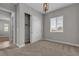 Well-lit bedroom with carpet, closet, and window offering outdoor view at 4829 E Beacon Ridge Dr, Pahrump, NV 89061