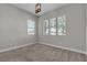Empty bedroom with carpeting, three windows, and neutral colors at 4829 E Beacon Ridge Dr, Pahrump, NV 89061