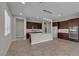 Spacious kitchen featuring dark wood cabinets, a center island, and stainless steel appliances at 4829 E Beacon Ridge Dr, Pahrump, NV 89061