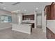 Bright kitchen with a large island, granite countertops, modern lighting, and dark wood cabinetry at 4829 E Beacon Ridge Dr, Pahrump, NV 89061