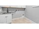 Practical laundry room with a utility sink, cabinets, granite countertops, and washer/dryer hookups at 4829 E Beacon Ridge Dr, Pahrump, NV 89061