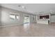 Open-concept living room and kitchen, with tile flooring, large windows, and ample natural light at 4829 E Beacon Ridge Dr, Pahrump, NV 89061
