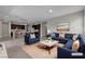 Open concept staged living room and kitchen with sleek furnishings, stylish decor, and ample space at 4829 E Beacon Ridge Dr, Pahrump, NV 89061