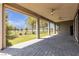 Covered patio with brick pavers, ceiling fans, and artificial turf backyard at 4829 E Beacon Ridge Dr, Pahrump, NV 89061