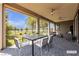 Covered patio with seating, ceiling fans, and artificial turf backyard at 4829 E Beacon Ridge Dr, Pahrump, NV 89061