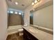 Modern bathroom featuring a tub-shower combo, tiled walls, and a vanity at 5699 Woodchester Ave, Las Vegas, NV 89139